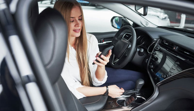 Woman on phone in car - sale of business