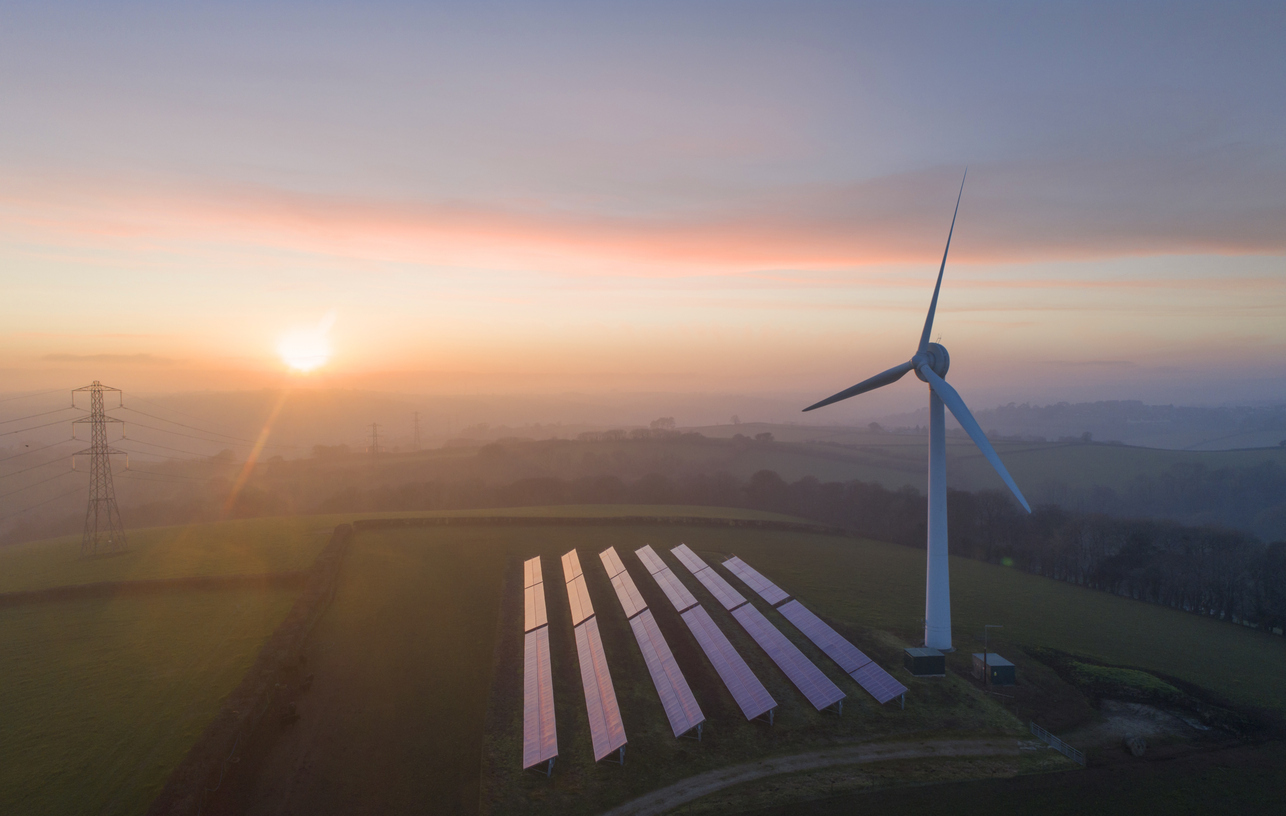  
Wind turbine and solar panels in field 
