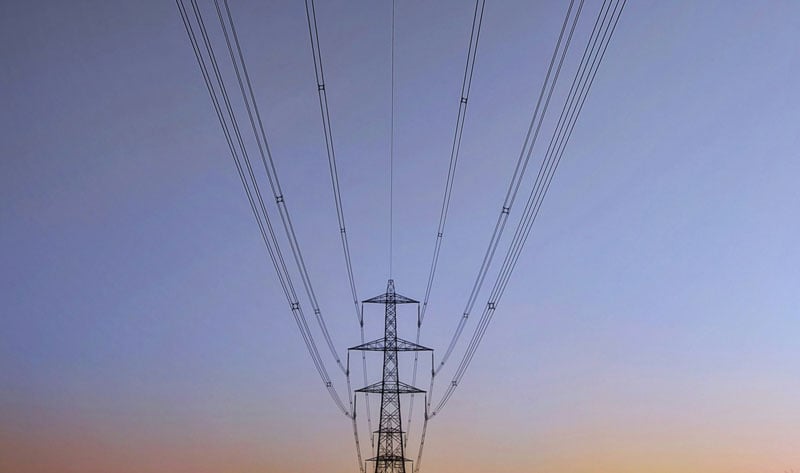 Pylon against clear sky, renewable energy plans