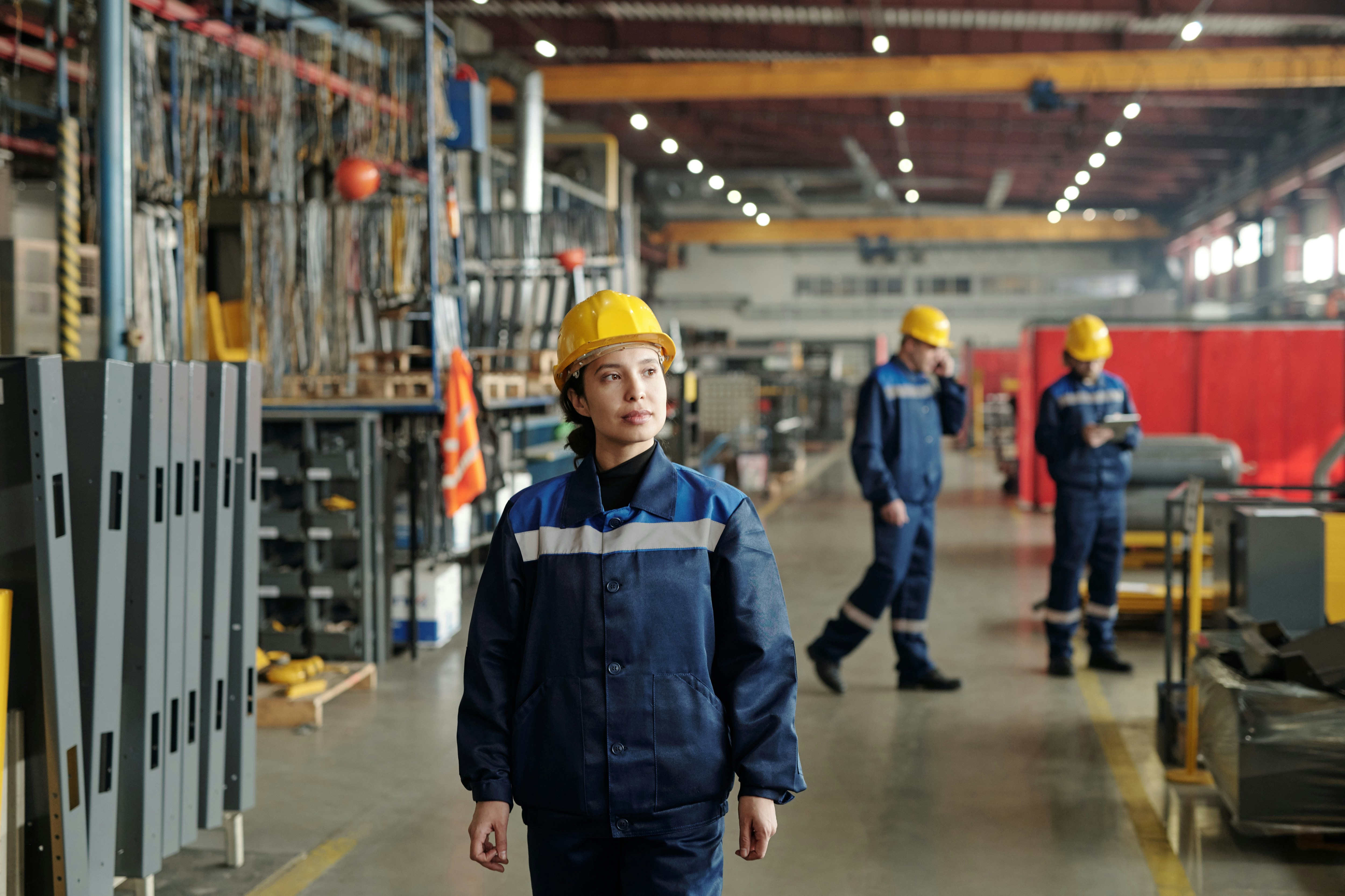 Worker walking in hard hat inside factory