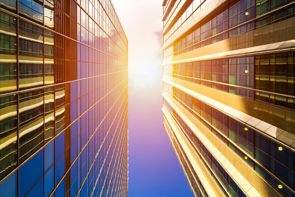 Cityscape Featuring Modern Office Exterior From A Low Angle At Sunset