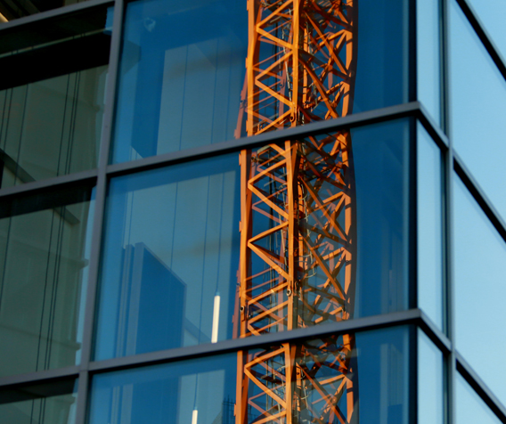 Crane reflection in window