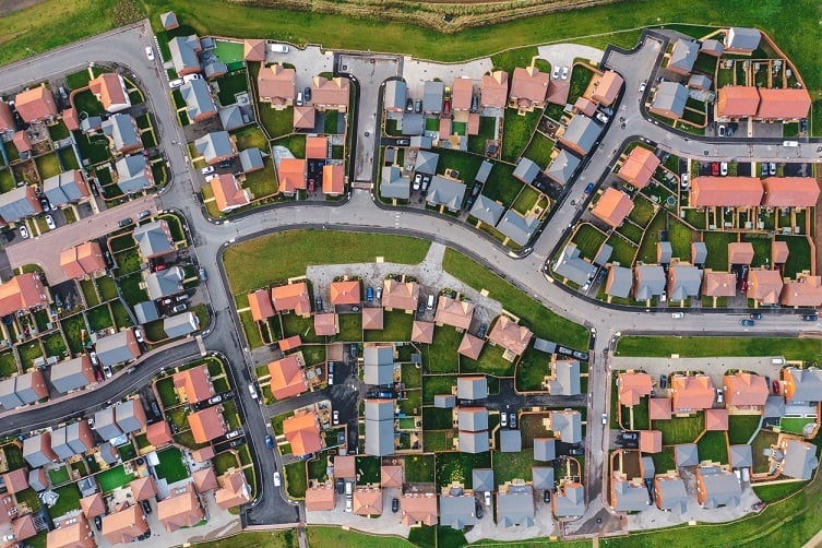  
View of houses along bending road from the sky
