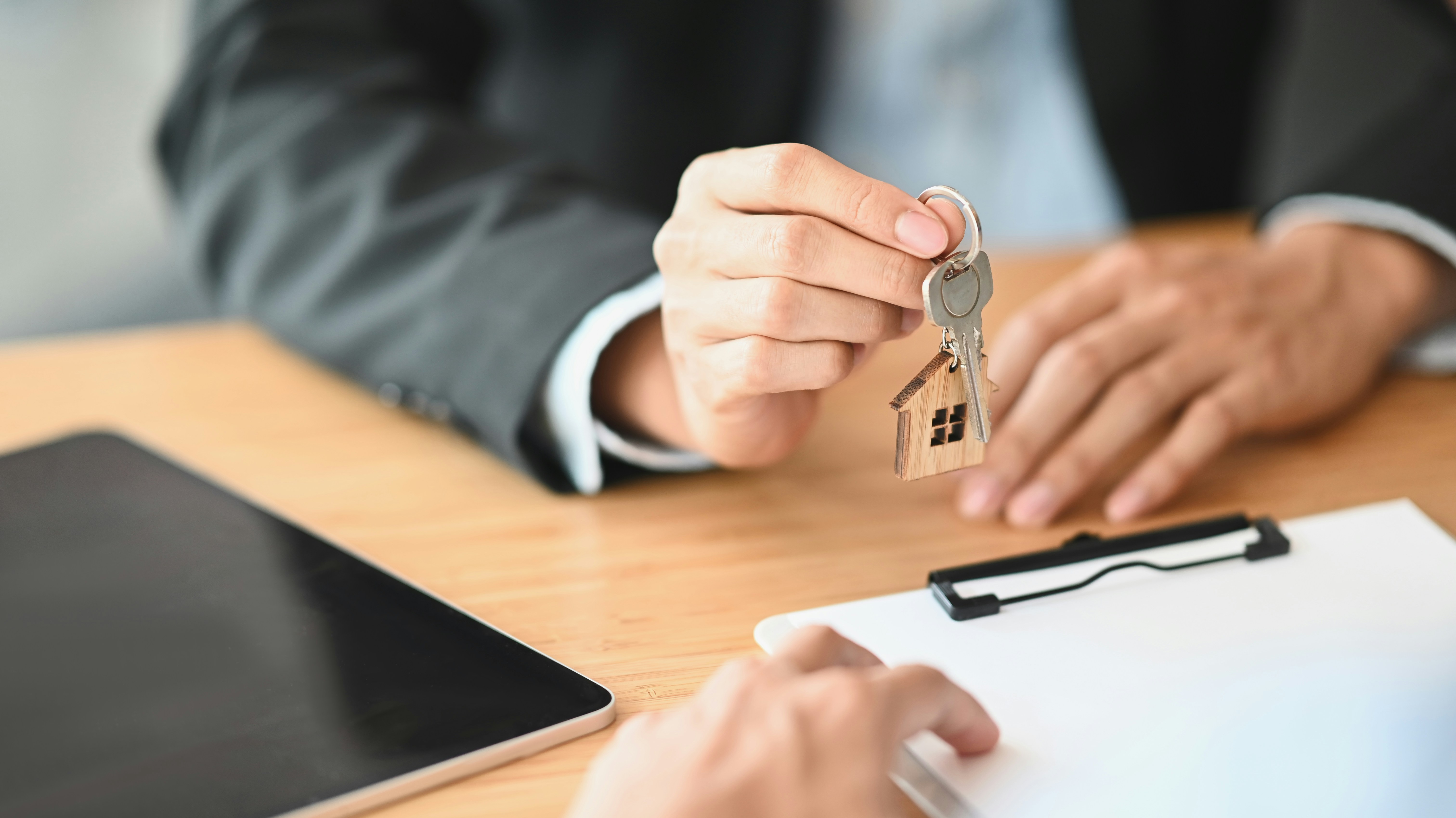 Person handing over house keys