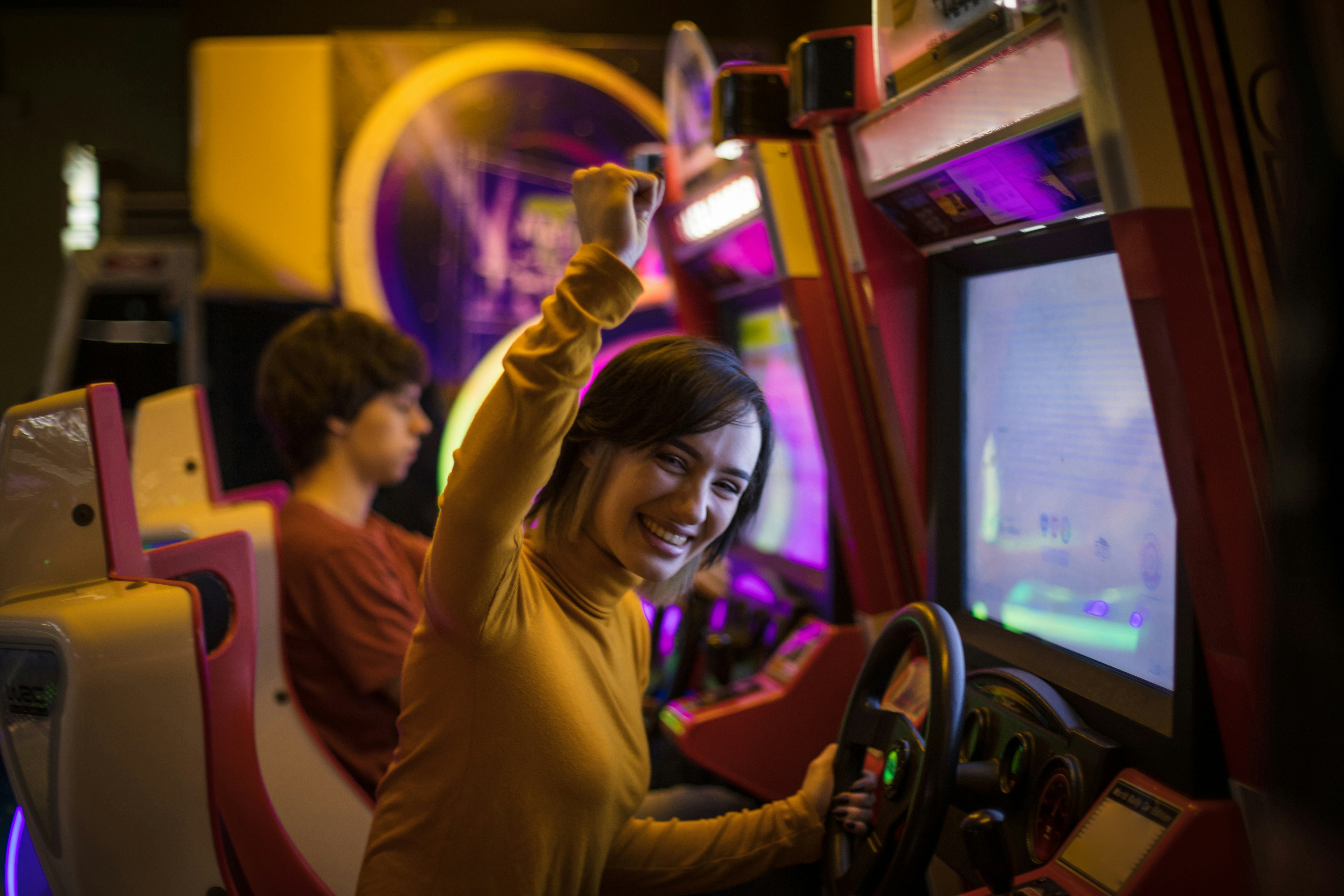 Person celebrating at arcade game